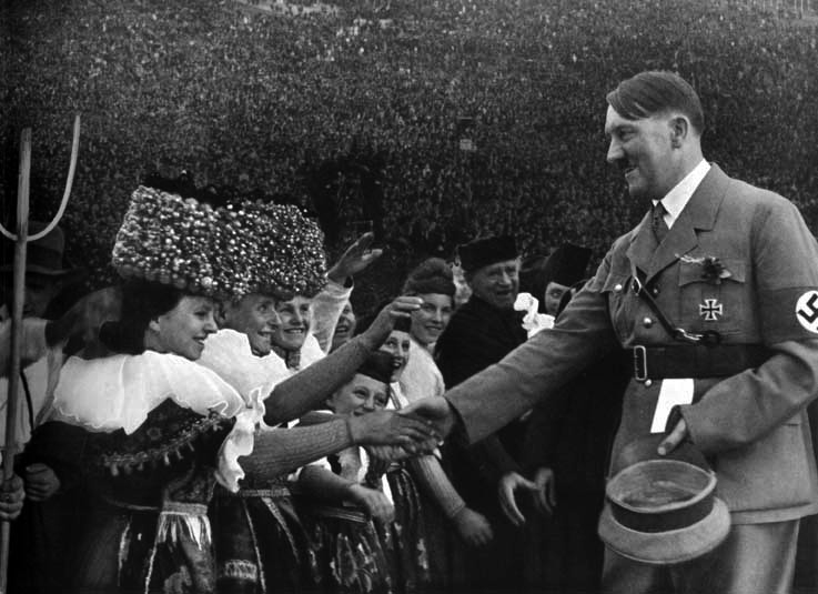 Adolf Hitler greets some women at the Erntedankfest on the Bückeberg
